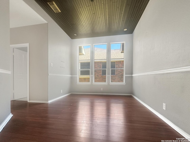 spare room featuring dark wood-type flooring and wooden ceiling