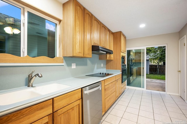 kitchen with sink, light tile patterned floors, a textured ceiling, and black appliances