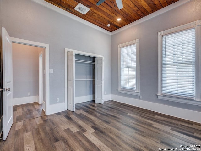 unfurnished bedroom with dark hardwood / wood-style floors, wooden ceiling, ceiling fan, and a closet