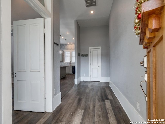 hall with dark wood-type flooring