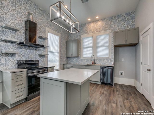 kitchen featuring gray cabinets, a kitchen island, black dishwasher, and electric stove