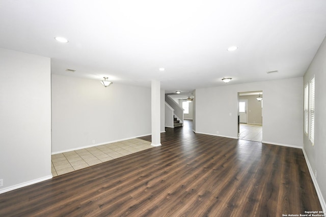 spare room with dark hardwood / wood-style flooring and ceiling fan