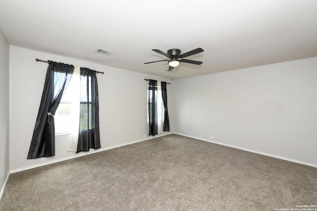 empty room featuring ceiling fan and carpet floors