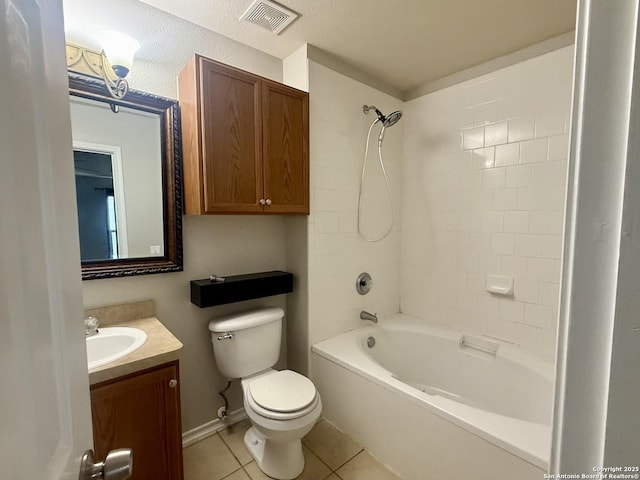 full bathroom with tile patterned flooring, tiled shower / bath, vanity, and toilet