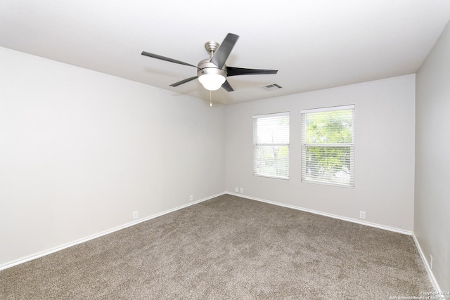 spare room featuring ceiling fan and carpet flooring