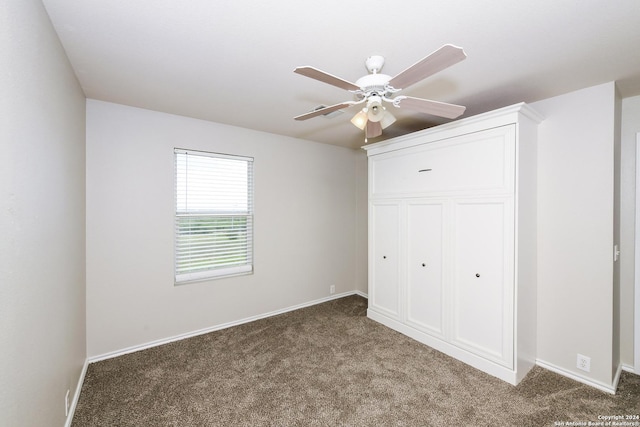 unfurnished bedroom with ceiling fan, carpet flooring, and a closet