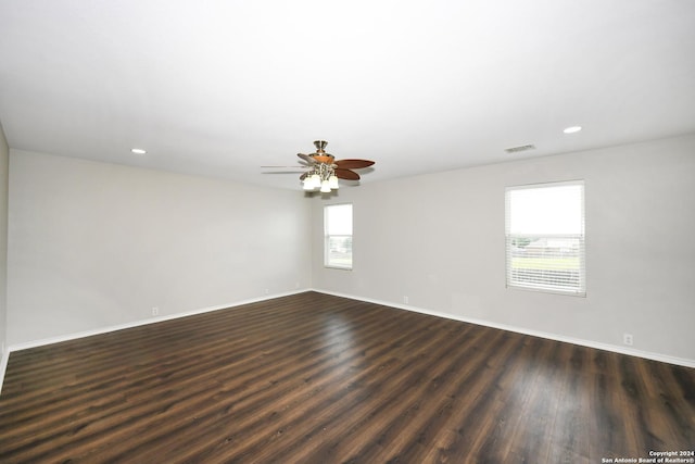 unfurnished room with dark wood-type flooring and ceiling fan