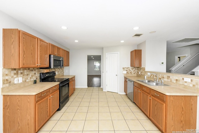 kitchen with stainless steel appliances, light tile patterned flooring, sink, and backsplash