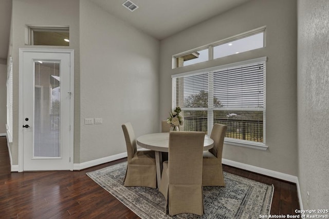 dining space with dark hardwood / wood-style flooring