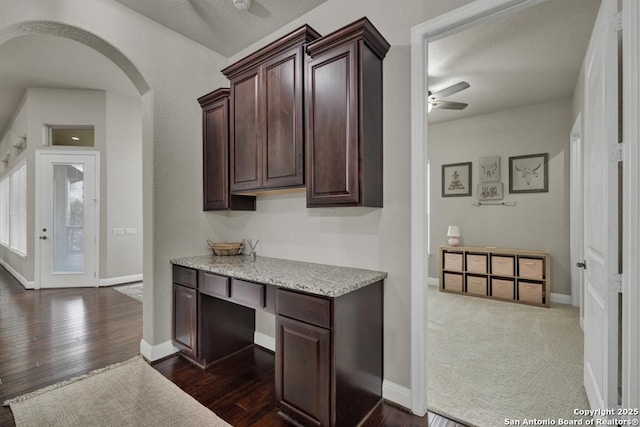 kitchen featuring dark brown cabinetry, dark wood-type flooring, and ceiling fan