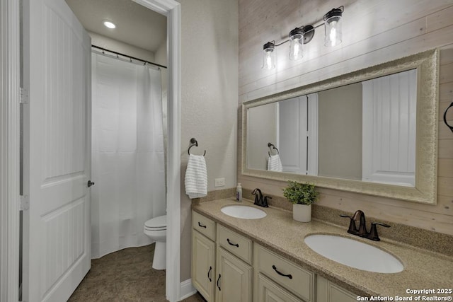 bathroom with walk in shower, vanity, and toilet