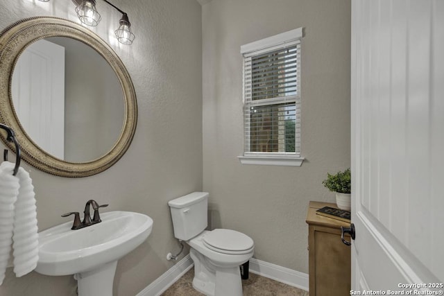 bathroom featuring toilet and sink