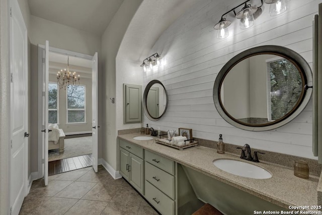 bathroom featuring vanity, a notable chandelier, and tile patterned floors