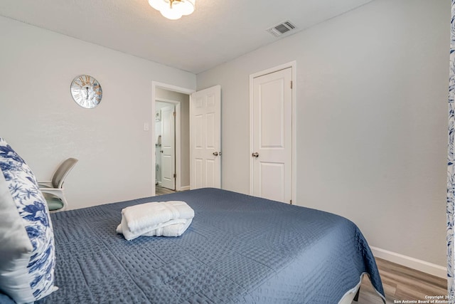 bedroom featuring wood-type flooring