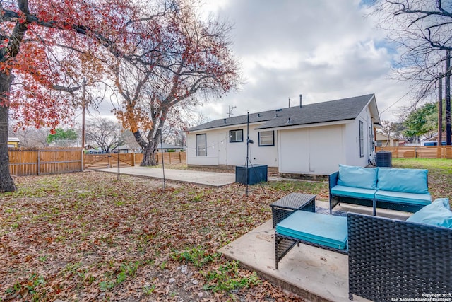 rear view of property featuring an outdoor living space, central AC, and a patio area