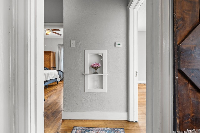 corridor featuring wood-type flooring