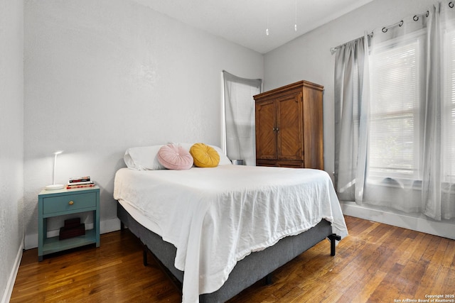 bedroom featuring dark wood-type flooring