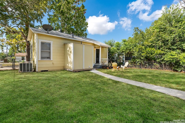 rear view of house featuring a yard