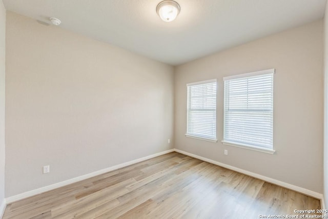 spare room featuring light wood-type flooring