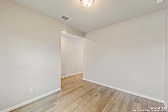 spare room with light hardwood / wood-style floors