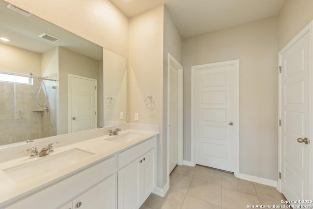 bathroom featuring tile patterned flooring, vanity, and a shower with door