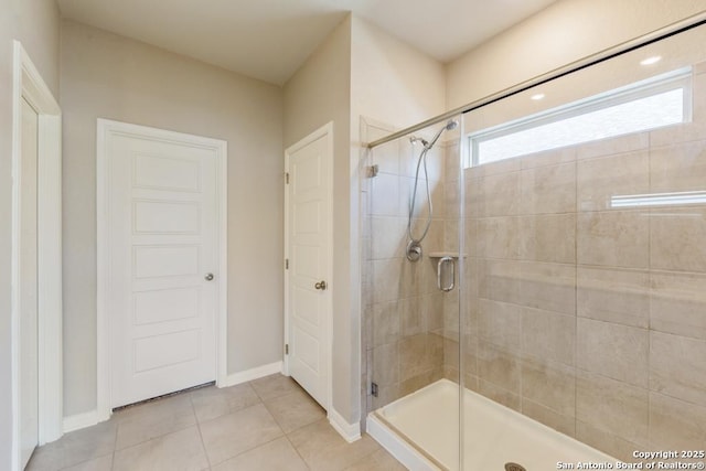 bathroom featuring an enclosed shower and tile patterned flooring