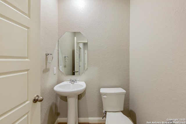 bathroom featuring toilet and sink