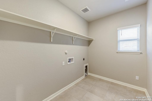 clothes washing area featuring hookup for a washing machine, electric dryer hookup, light tile patterned floors, and hookup for a gas dryer