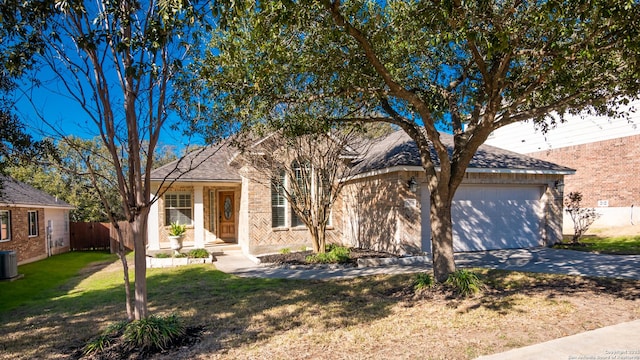 view of front of house featuring a garage, central air condition unit, and a front lawn