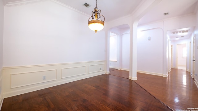 unfurnished room featuring dark wood-type flooring and crown molding