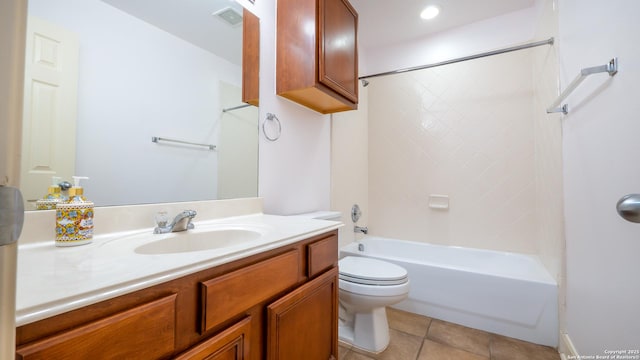 full bathroom featuring tile patterned flooring, vanity, tiled shower / bath, and toilet