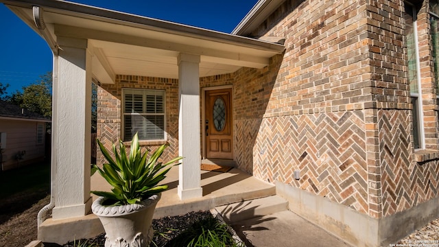 entrance to property featuring a porch