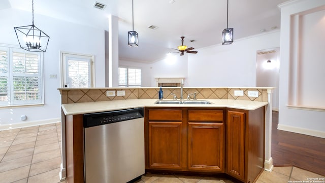 kitchen with decorative backsplash, dishwasher, sink, and hanging light fixtures