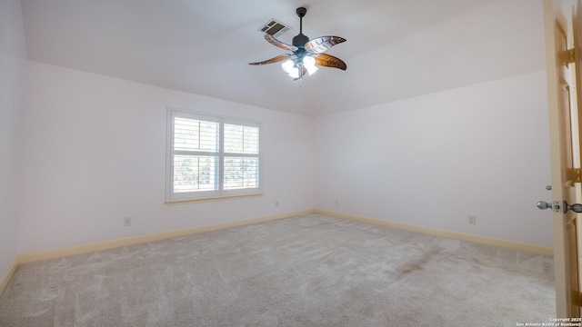 spare room featuring light colored carpet and ceiling fan