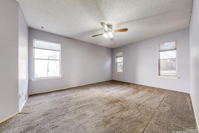 unfurnished room with ceiling fan, carpet, and a textured ceiling