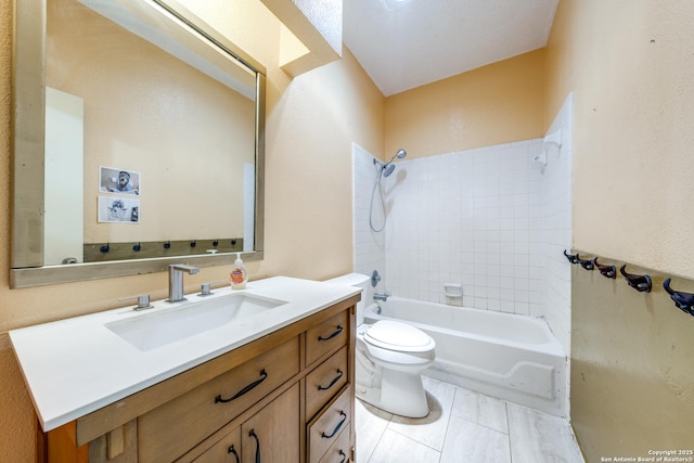 full bathroom with tiled shower / bath, vanity, and toilet