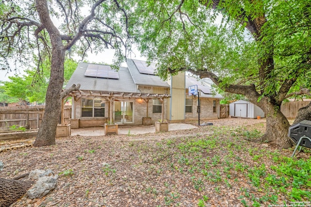 9018 Brickwood, San Antonio, TX 78250 - back of property with a pergola, a patio, a fenced backyard, a shed, and solar panels