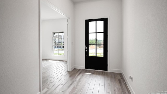 3157 Bee Hl, Schertz, TX 78108 - entryway featuring wood finished floors, baseboards, and a textured wall
