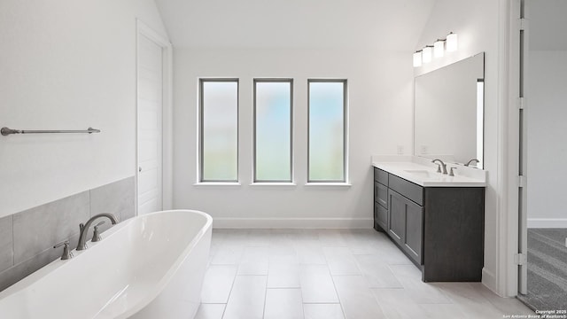 3157 Bee Hl, Schertz, TX 78108 - bathroom with a freestanding tub, vanity, baseboards, tile patterned flooring, and lofted ceiling