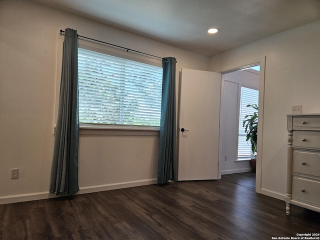 unfurnished room with dark hardwood / wood-style floors