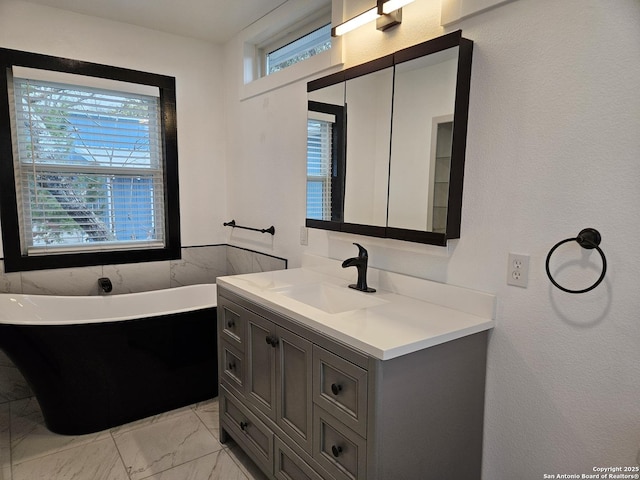 bathroom with vanity and a tub to relax in