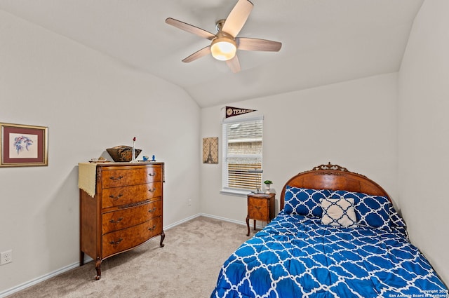 carpeted bedroom featuring ceiling fan and vaulted ceiling