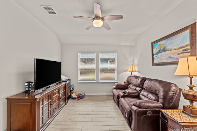 living room with ceiling fan and vaulted ceiling