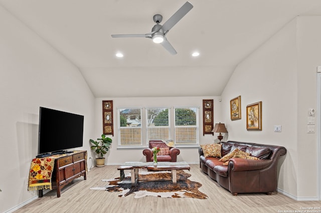 living room featuring vaulted ceiling, ceiling fan, and light wood-type flooring