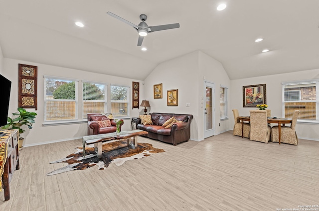 living room featuring ceiling fan, vaulted ceiling, and light hardwood / wood-style flooring