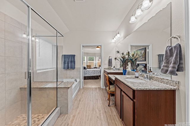 bathroom featuring vanity, independent shower and bath, and ceiling fan