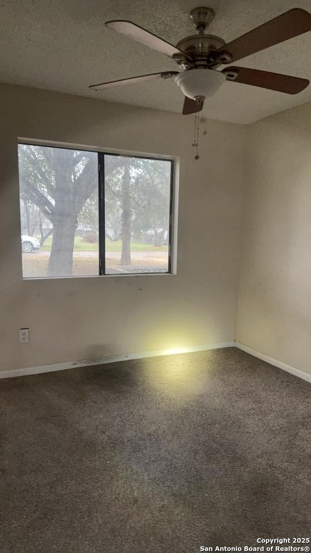 521 Quail Ln, Floresville, TX 78114 - unfurnished room with a textured ceiling and carpet