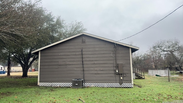 521 Quail Ln, Floresville, TX 78114 - view of outdoor structure featuring central AC unit and a lawn