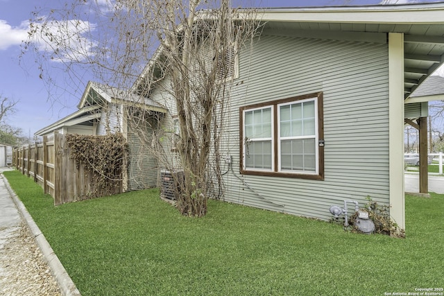 view of side of home with a yard