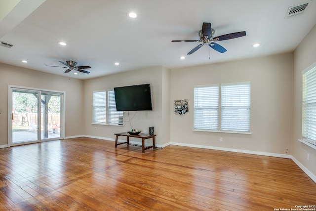 unfurnished living room featuring light hardwood / wood-style flooring and ceiling fan